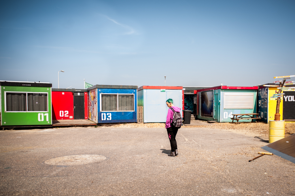 row of colourful shipping containers, serving as hostel and containing over 50 beds